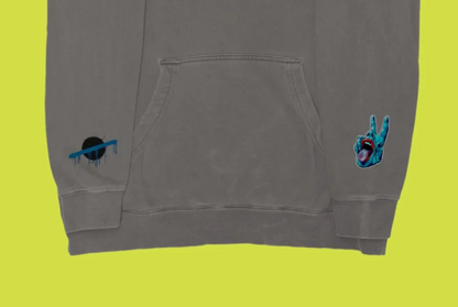 Carve Collective OW Splatter pigment cement hoodie, front pocket and sleeve artwork detail.